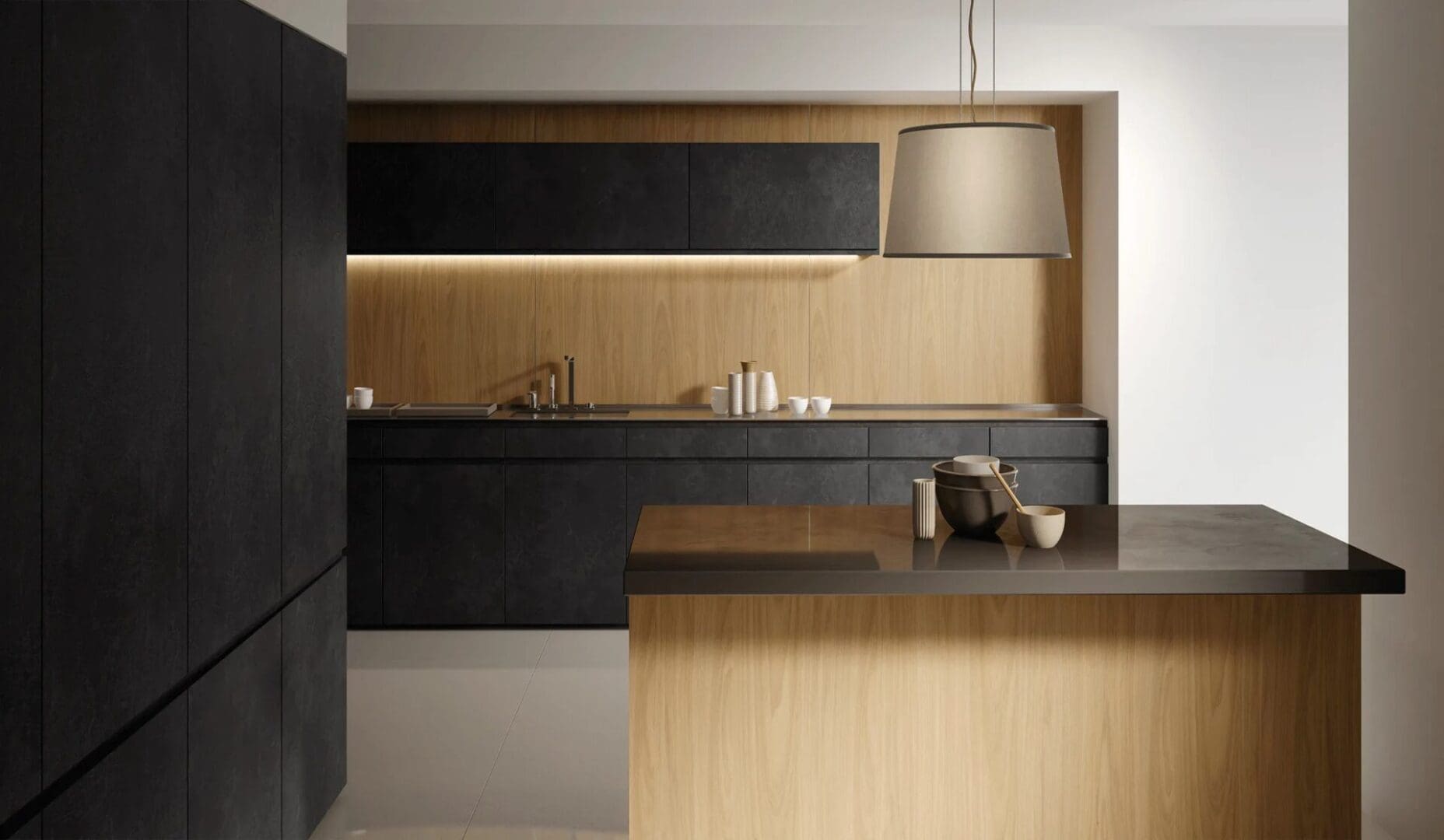 A kitchen with black cabinets and wooden walls.